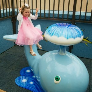 girl with metal whale sculpture